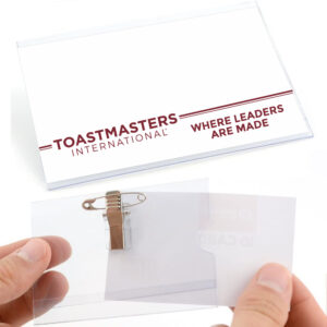 A plastic badge displaying Toastmaster International Contest Certificates.