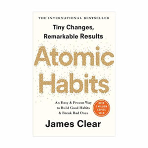 Habits Book Cover - A book with the title "Atomic Habits" written by James Clear displayed on a background.