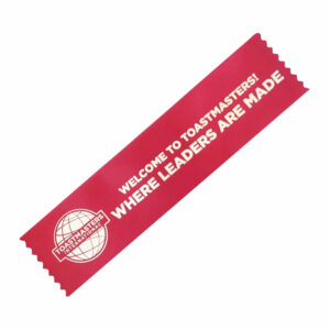 Welcome to Toastmasters ribbon with a red background and white text.
