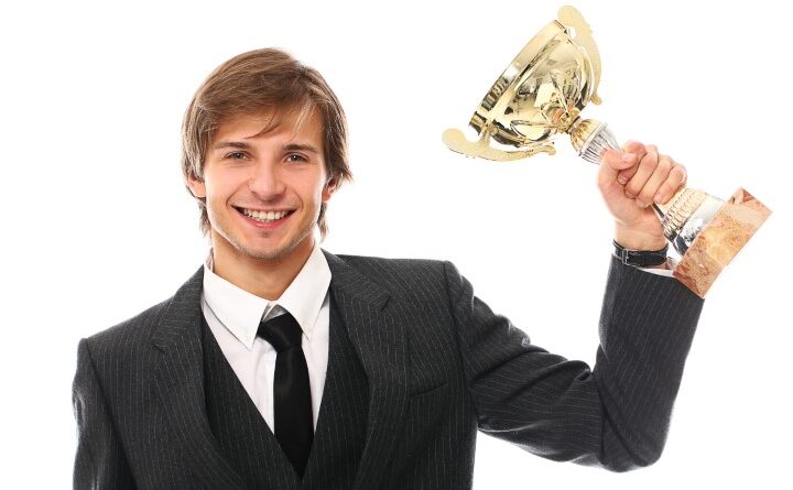 Young Businessman with Trophy